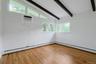 Bedroom # 2 with hardwood floor and beamed ceiling