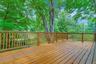 Another view of the deck show casing the mature trees on the property.