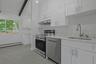 White cabinets, quartz countertops and all new stainless steel appliances