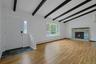 Living room with stunning hardwood floors, stone fireplace and beamed cathedral ceiling