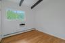 Bedroom # 1 with hardwood floor and beamed ceiling
