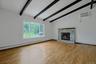 Another view of the living room featuring the large window for lots of natural light