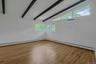 Spacious Primary bedroom with hardwood floor and beamed ceiling