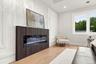 Another Beautiful CUSTOM fireplace with wainscoting wall feature in Primary Bedroom