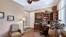 Partial view of current home office with build in cabinetry and private balcony.