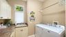 Laundry room with lots of hanging space, folding space and storage for your cleaning supplies.