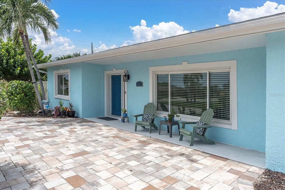 Pavered circular driveway and covered two-car carport provide plenty of convenient off-street parking.