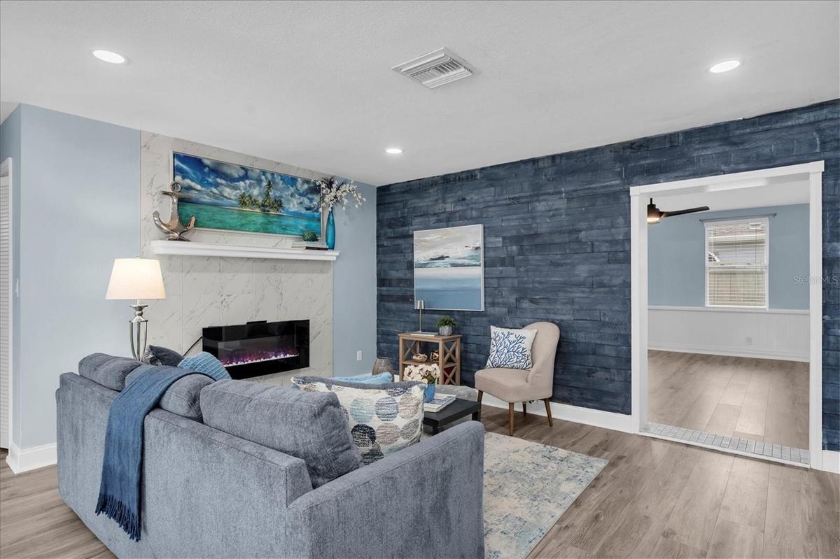 Blue shiplap accent wall brings coastal character to the main living space.