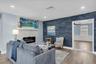 Blue shiplap accent wall brings coastal character to the main living space.