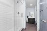 Conveniently located just steps from the family room, this beautifully appointed bathroom features a walk-in shower with classic subway tile and a fra