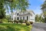 This elegant Colonial showcases timeless architecture, manicured grounds, an expansive driveway, and exceptional curb appeal, creating a welcoming set