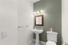 Conveniently located on the main level, the powder room adds comfort and convenience for guests, thoughtfully completing the home's well-designed livi