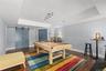 Designed for fun and entertainment, this spacious game room features an elegant tray ceiling, task lighting, and warm wood-toned flooring, with ample 