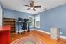 The second upstairs bedroom, currently utilized as a home office, shares the thoughtfully designed adjoining bath and offers versatile living space th