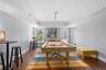 Abundant natural light streams through the large window and glass doors, enhancing the game room’s bright, inviting atmosphere and creating a welcomin
