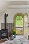 Entrance and wood burning stove in the Poolside Cottage