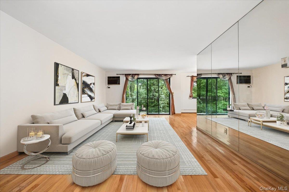 Living room view 1 -from foyer, leading to balcony, virtually staged