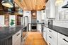 Brand new kitchen with stainless steel appliances, and subway tile backsplash