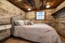 Bedroom with reclaimed wood and flush mount lights