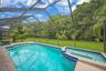 Spa with waterfall into solar heated pool