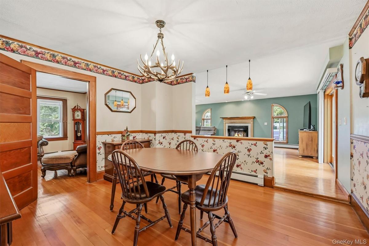 Formal dining room with hardwood floors and an open view into the spacious family room.