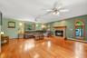 Spacious family room featuring hardwood floors, a fireplace, and distinctive arched windows.