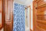Full bathroom with tub/shower combination and built-in storage.