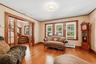Living room featuring hardwood floors, wood trim, and French doors.