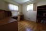 Hardwood flooring, painted walls, and multiple windows