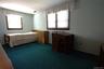 Wall-to-wall carpeting and multiple windows with wood trim