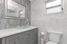 Remodeled Full "Pool Side" Bathroom with elevated fixtures, Shower with Tile to Ceiling and Recessed Decorative Niche; Statement Sink basin; Located o