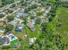 View of Backyard, Playground, Two Covered Open-Air Structured Storage areas with Concrete Pads, Firepit, and Shed. Bring the Boat- Bring the Toys - Th