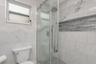 Remodeled Full "Pool Side" Bathroom with elevated fixtures, Shower with Tile to Ceiling and Recessed Decorative Niche; Located off the Kitchen