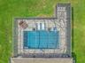 Aerial View of Custom Pool Cage & Pool with additional seating area; pavered deck area; and electric shades.