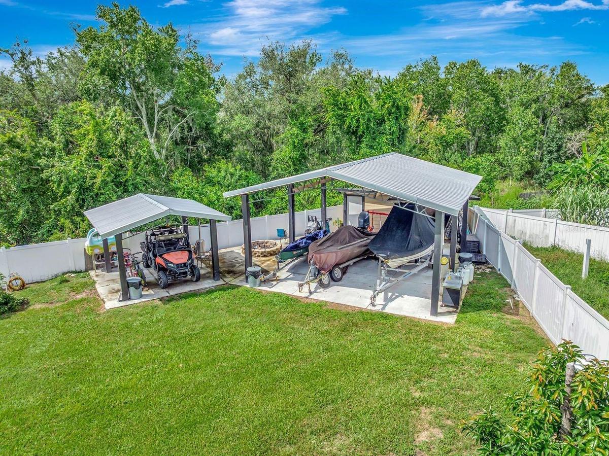 Aerial View of Two Covered Open Air Storage Areas with Concrete Pads, Firepit, Shed and enough parking for all of your toys!