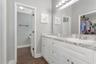 En-Suite Primary Bathroom; Dual Vanities; White Cabinets; LVP Flooring; Walk-In closet; Shower