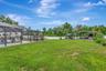 View of Backyard, Playground, Two Covered Open-Air Structured Storage areas with Concrete Pads, Firepit, and Shed. Bring the Boat- Bring the Toys - Th