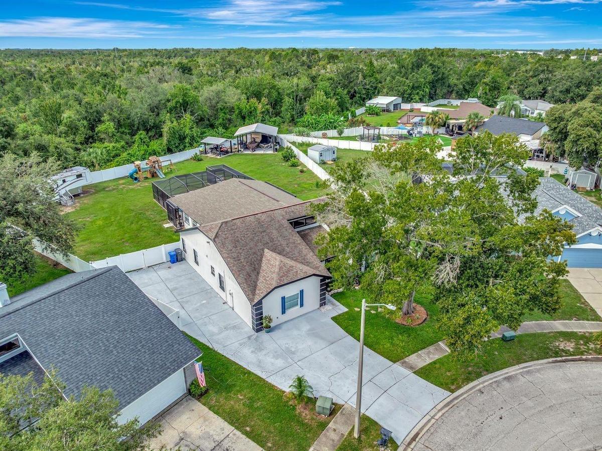 Aerial View of 4 Bedroom Pool Home with extended driveway, side driveway, tons of parking for RV, Boats, Toys, and more!