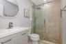 Remodeled Full Bathroom with upgraded fixtures, lighting, Shower with TIle to Ceiling and decorative patterns; upgraded mirror