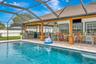 View of Pool, Extended and Covered Rear Porch, Lanai, and Summer Kitchen