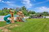 View of Backyard, Playground, Two Covered Open-Air Structured Storage areas with Concrete Pads, Firepit, and Shed. Bring the Boat- Bring the Toys - Th