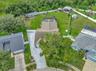 View of Backyard, Playground, Two Covered Open-Air Structured Storage areas with Concrete Pads, Firepit, and Shed. Bring the Boat- Bring the Toys - Th