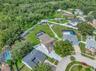 View of Backyard, Playground, Two Covered Open-Air Structured Storage areas with Concrete Pads, Firepit, and Shed. Bring the Boat- Bring the Toys - Th