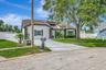 Aerial View of Home; Expanded Driveway; Sidewalks; Mature Landscaping; Double Gates; and More!