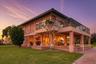 Twilight exterior highlighting the expansive covered outdoor living area.