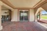 Covered ground-level patio with direct access through sliding glass doors.