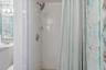 Walk-in shower detail with tiled surround.