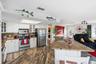 Bright kitchen featuring white cabinetry, extensive countertops, and stainless appliances.