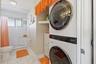 Bathroom and laundry area with stacked washer and dryer.