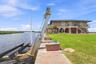 Seawall-mounted boat lift providing convenient vessel storage and direct water access.